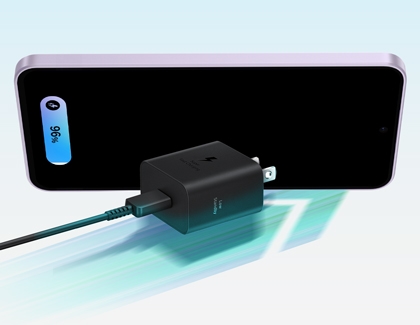 A Galaxy A37 screen showing 96 percent battery life while a black Super Fast Charging wall masonry plug with a cable sits in front.