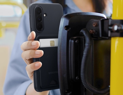 A hand holding a Galaxy A37 in a black card slot case against a transit reader to pay with a credit card.