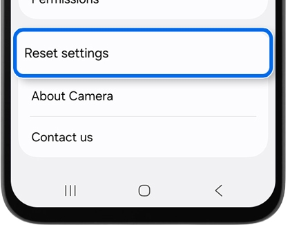 Close up of a phone screen with the Reset settings option highlighted by a blue rounded border.