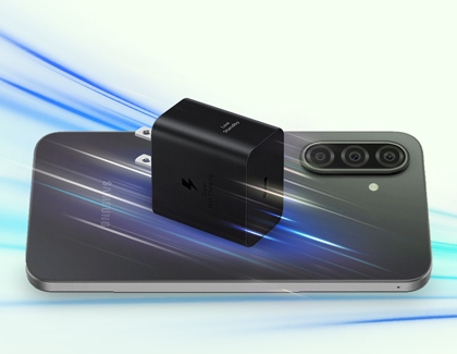 Black Samsung wall charger resting on the back of a Galaxy A17 with blue light trails effect.