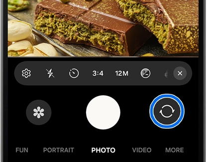 Camera app interface with a blue circle highlighting the icon used to switch between cameras.