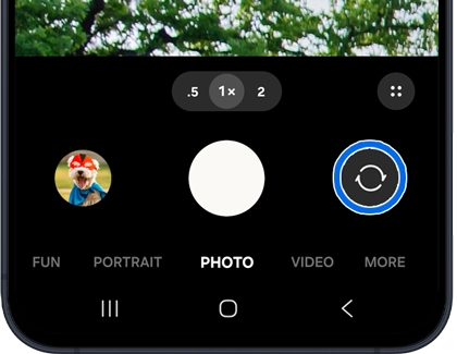 A Galaxy A series phone screen showing the camera app with the switch camera icon highlighted in a blue circle.
