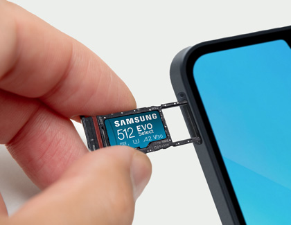 Inserting a Samsung 512 GB EVO memory card into the SIM and memory card tray of a Samsung Galaxy A16 phone.