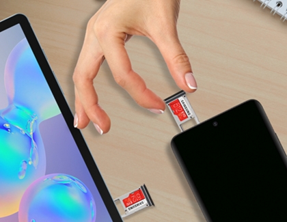 Hand removing a microSD card from a phone