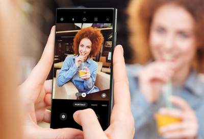 Woman posing to a Galaxy S23 ultra using Portrait mode