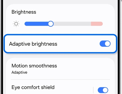 Display settings on the Galaxy S25 Ultra, with Adaptive brightness highlighted and toggled on.