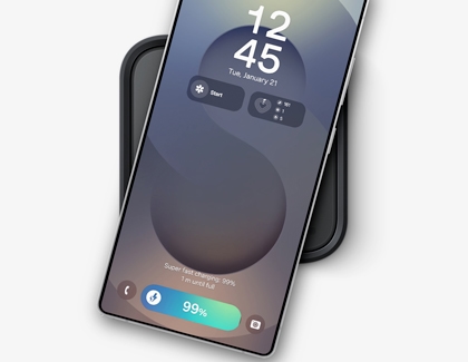A Galaxy S25 Ultra placed on a wireless charger showing the lock screen with charging status at 99 percent.
