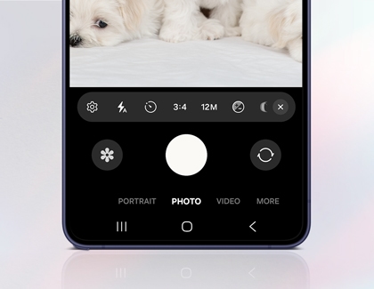 A purple Galaxy S26 Ultra showing the camera app with quick control icons for settings flash timer aspect ratio and resolution above the capture button.