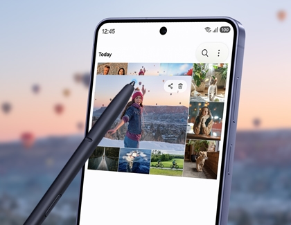 A purple Galaxy S26 Ultra showing a photo gallery, with a stylus pen hovering over a picture to enlarge it.