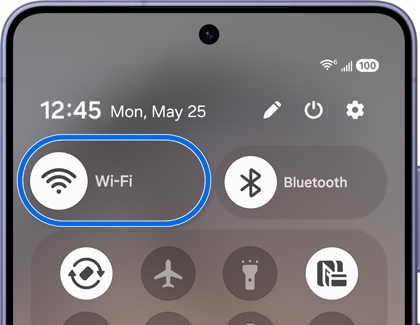 Quick settings panel showing the Wi-Fi icon being tapped.