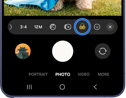 A Galaxy phone showing the Camera app in Photo mode with the Filters icon highlighted in blue in the top toolbar.