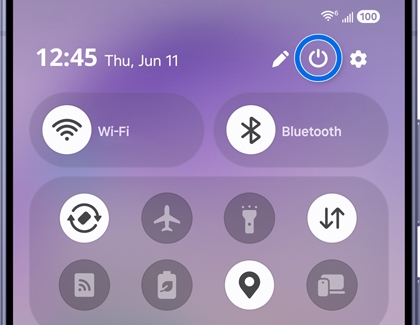 A Galaxy phone showing the quick settings panel with the power icon highlighted in a blue circle.