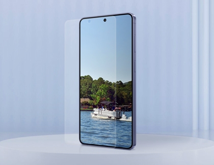 A purple Galaxy S26 Ultra displaying a landscape image on the screen, with a clear screen protector film being applied.