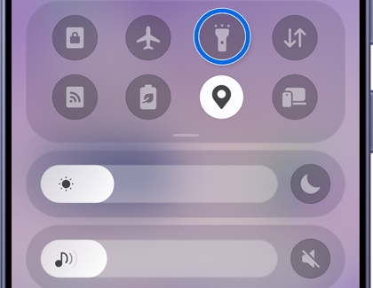 A Galaxy phone screen showing the Quick Settings panel with the flashlight icon highlighted.