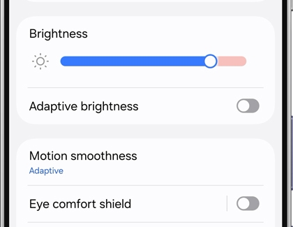 A Galaxy phone screen showing display settings with the Brightness slider highlighted.