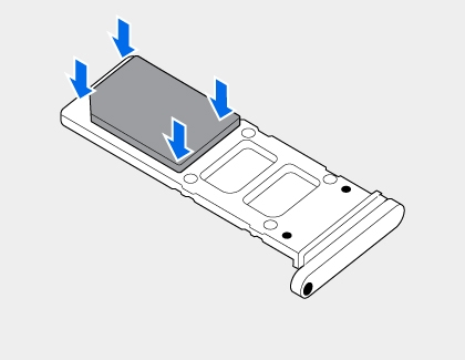 SIM card being placed into a tray with four blue arrows pointing down at the card corners.