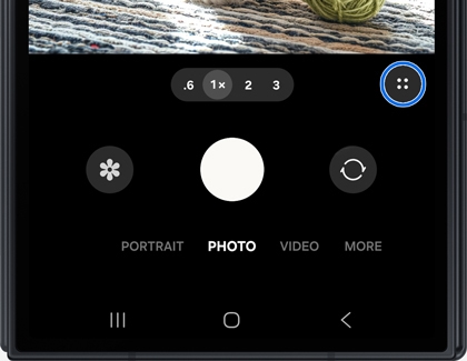 Camera interface on the Galaxy Z TriFold with a blue circle highlighting a four dot icon.