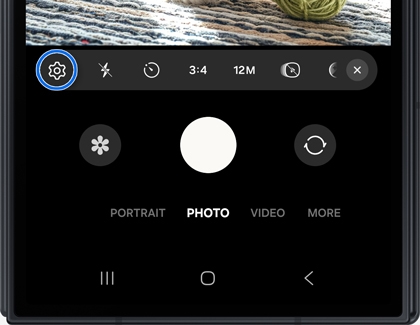 Camera interface on the Galaxy Z TriFold with a gear icon highlighted in a blue circle.