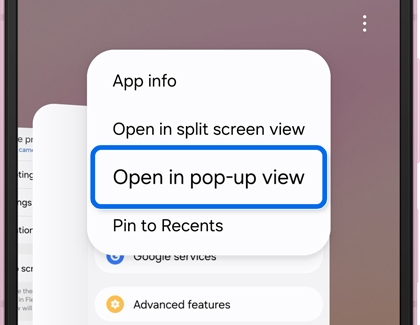 A Galaxy phone screen showing a menu with the Open in pop up view option highlighted.