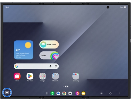 The Home screen of an unfolded Galaxy Z TriFold with the Touchpad icon in the bottom left corner highlighted in a blue circle.