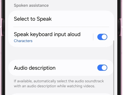 Galaxy device screen displaying Spoken assistance settings with Speak keyboard input aloud and Audio description toggles turned on.