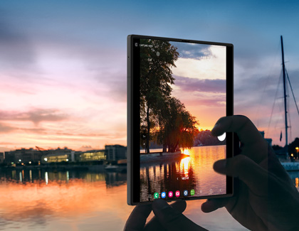Person taking a photo of the sunset using the main screen of the Galaxy Z Fold6