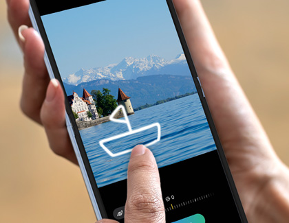 Hand holding a Galaxy Z Flip6 while sketching a boat onto a picture of a river