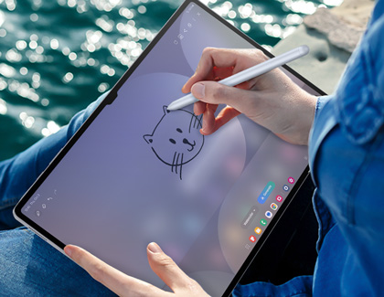 A person sketching a cat on a Galaxy Tab S10 Ultra while using the S Pen