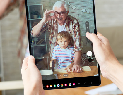 Person using a Galaxy tablet to take a picture in Pro mode