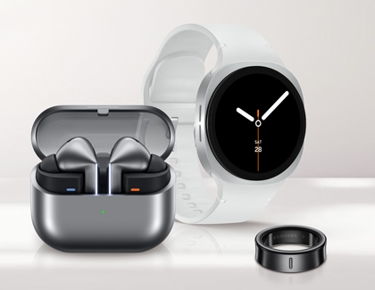 Galaxy Buds3 Pro in an open charging case next to a Galaxy Watch and Galaxy Ring.
