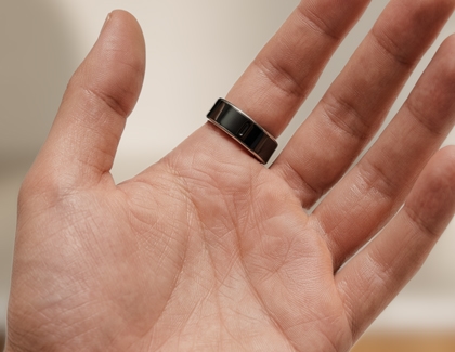 A hand palm side up showing the Galaxy ring being worn with the embossed indicator aligned with the palm. 