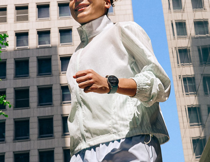 A Woman jogging while wearing a Galaxy Watch