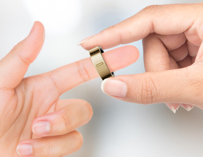 Galaxy Ring being placed on the index finger