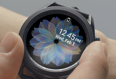 A Galaxy Watch Active 2 next to a phone with the Galaxy Wearable app opened - Watch running well