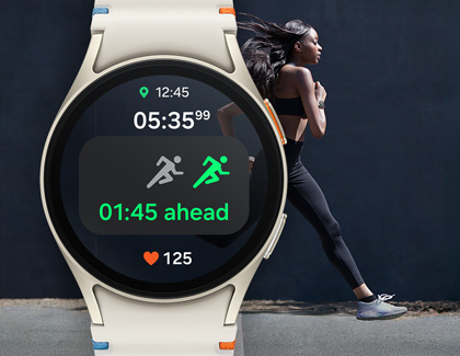 A woman running outdoors wearing a Galaxy Watch7, which displays a running workout screen showing elapsed time, distance, and heart rate.