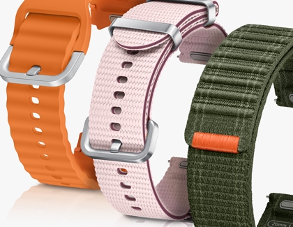 Three different Galaxy Watch7 bands in orange, pink, and green colors, showcasing various styles and clasp designs.