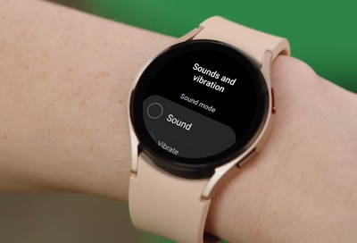 Person looking at Galaxy Watch4 displaying Sound and vibration settings