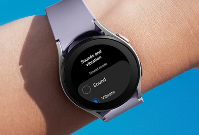 Person looking at Galaxy Watch5 displaying Sound and vibration settings