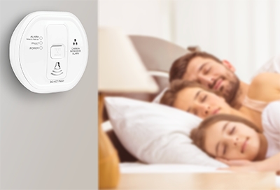 An ADT Carbon Monoxide Alarm on a bedroom wall