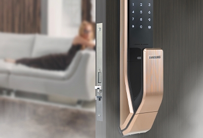 A smart lock attached to the front of a door