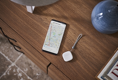 The SmartThings tracker on table next to phone
