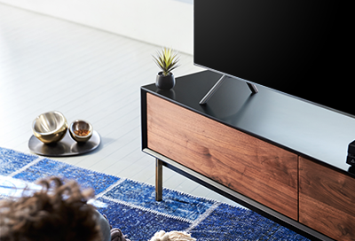 Samsung TV on a low coffee table in a minimalist, modern living room