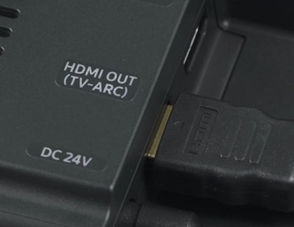 Close-up of an HDMI cable connected to the HDMI OUT (TV-ARC) port on a Samsung soundbar.
