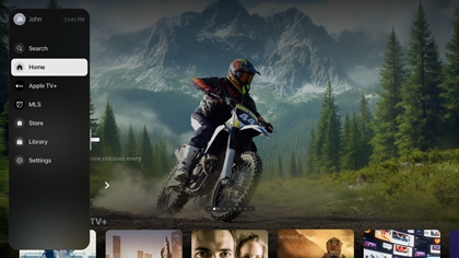 Apple TV interface on a Samsung TV with the Home tab selected and a dirt bike rider shown in the background.