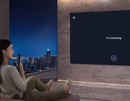 A person using a remote while Copilot Im listening screen is displayed on a Samsung TV
