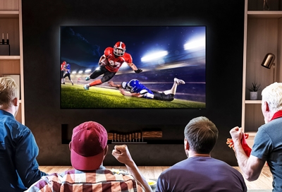 Four friends watching their favorite sports on Samsung TV