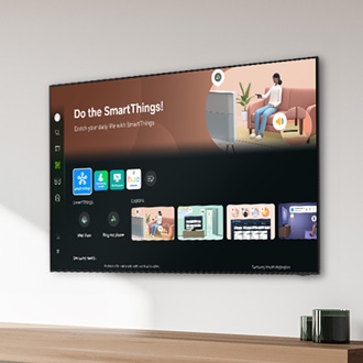 A 2024 Samsung TV mounted on a wall in a modern living room displaying the home screen