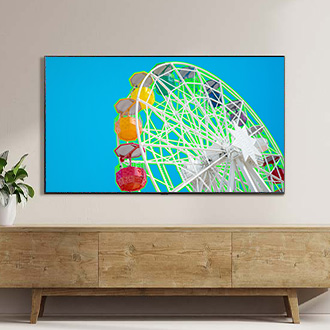 Wall-mounted Samsung TV in a modern living room, displaying a ferris wheel with Relumino mode activated