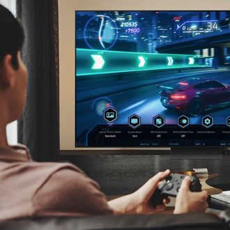 Man playing video games on a Samsung TV with the Game Bar displayed