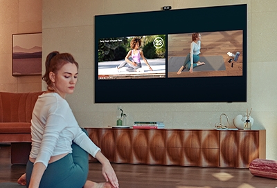 Girl working out in front of 2021 QLED TV